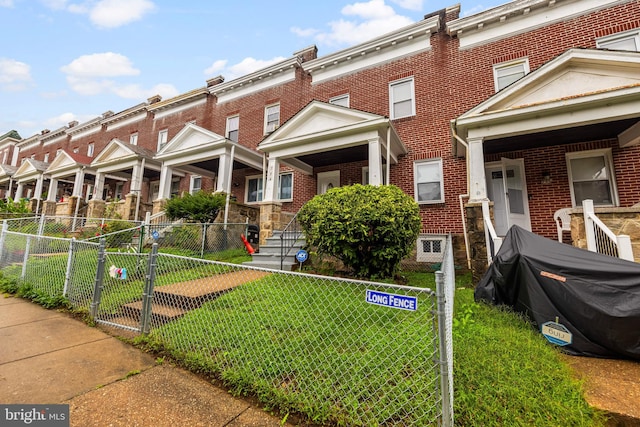 view of property featuring a front lawn