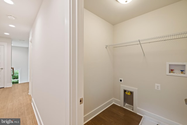 laundry area with light hardwood / wood-style floors, hookup for an electric dryer, and washer hookup