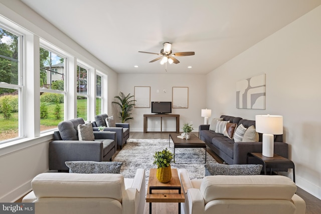 living room featuring hardwood / wood-style floors and ceiling fan