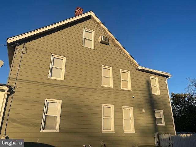 back of house featuring a wall mounted air conditioner