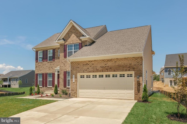 view of front of home with a front lawn and a garage