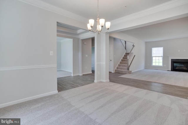 interior space featuring ornamental molding, a tray ceiling, hardwood / wood-style floors, and an inviting chandelier