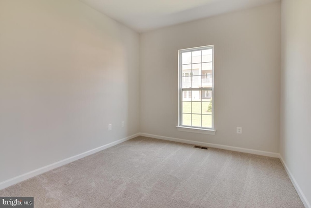 empty room featuring light carpet