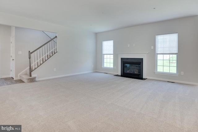 unfurnished living room with light carpet