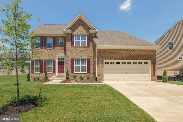 view of front facade with a front yard and a garage