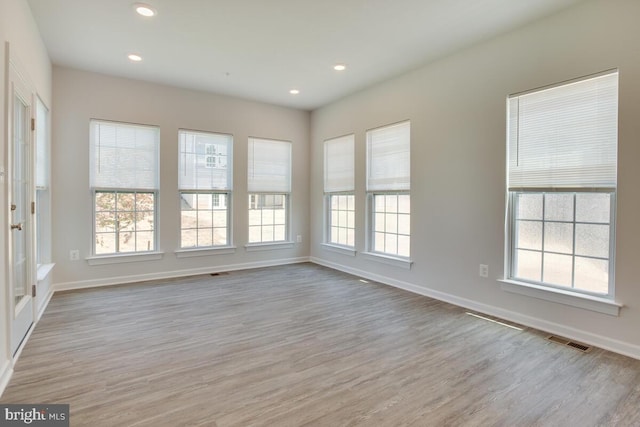 unfurnished room featuring light hardwood / wood-style floors