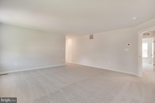 spare room featuring light colored carpet