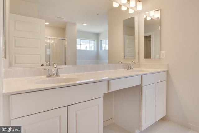 bathroom featuring walk in shower, tile patterned floors, and vanity