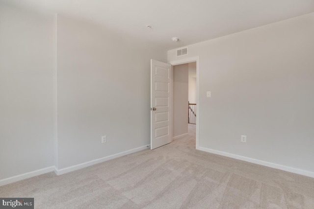 empty room featuring light carpet