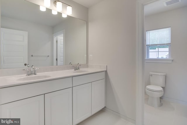 bathroom with vanity, toilet, and tile patterned floors