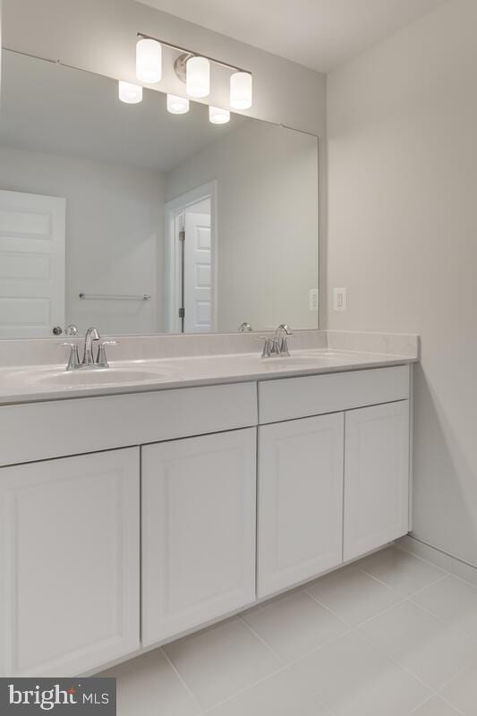 bathroom with tile patterned flooring and vanity