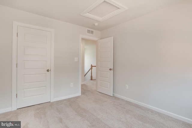 unfurnished room with light colored carpet