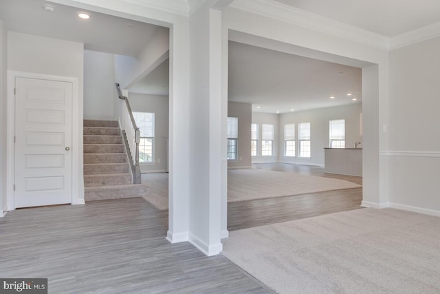 foyer featuring light hardwood / wood-style flooring and ornamental molding