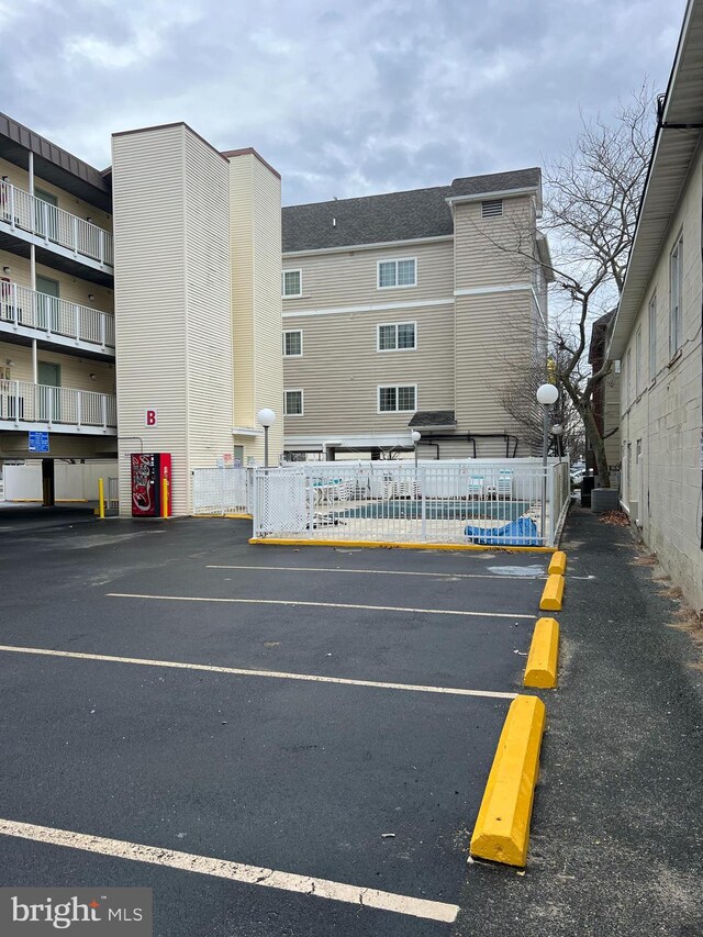 view of parking with a pool