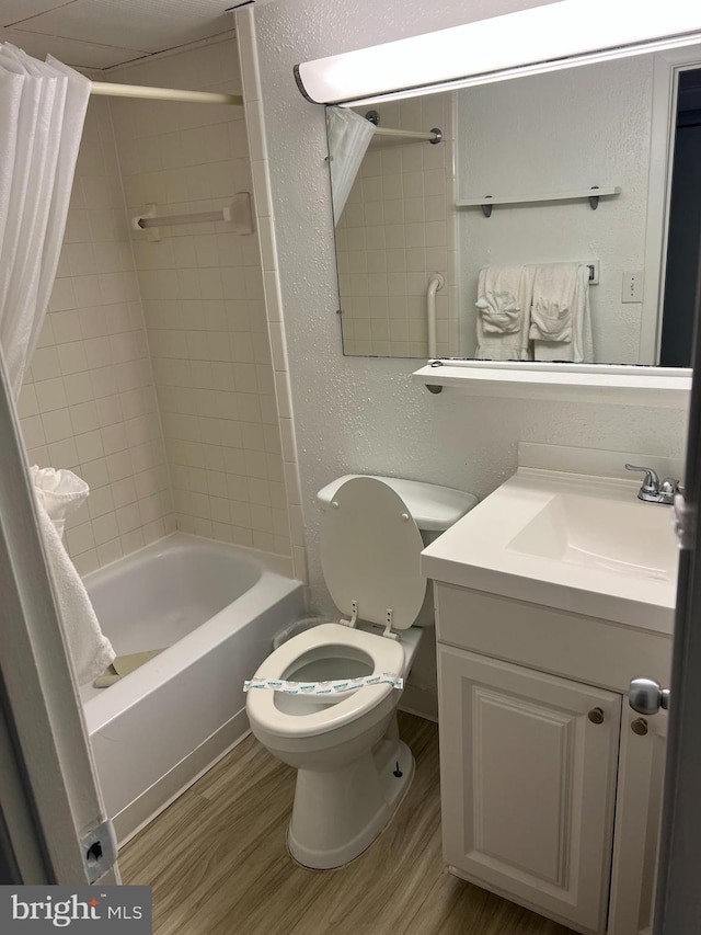 full bathroom with shower / bath combination with curtain, wood-type flooring, vanity, and toilet