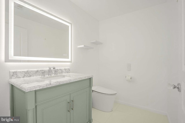 bathroom featuring vanity, toilet, and tile patterned floors