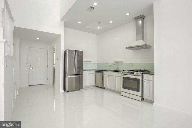 kitchen with wall chimney exhaust hood, sink, appliances with stainless steel finishes, and tasteful backsplash