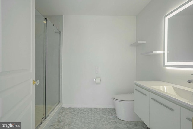 bathroom featuring vanity, a shower with shower door, toilet, and tile patterned floors