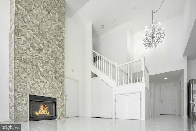 stairs featuring a tiled fireplace and high vaulted ceiling