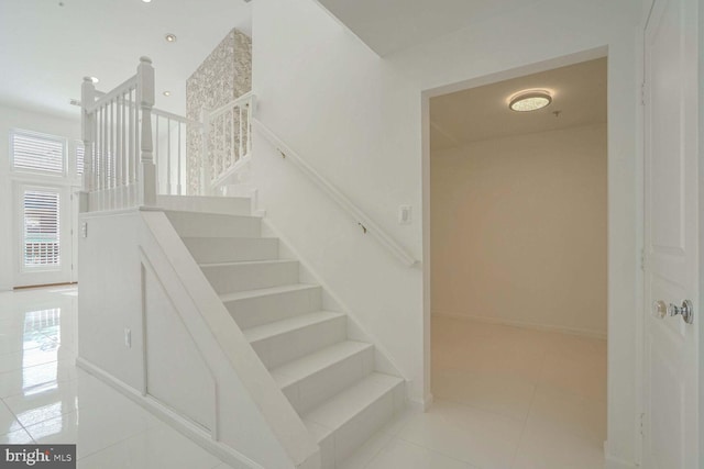 staircase featuring tile patterned floors