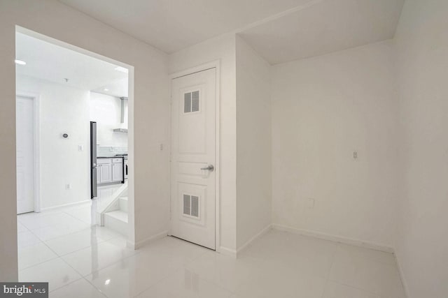 hallway with light tile patterned flooring