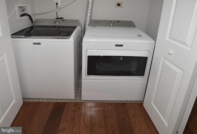 clothes washing area with independent washer and dryer and dark hardwood / wood-style flooring