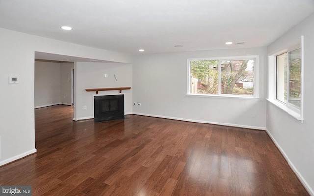 unfurnished living room featuring dark wood-type flooring