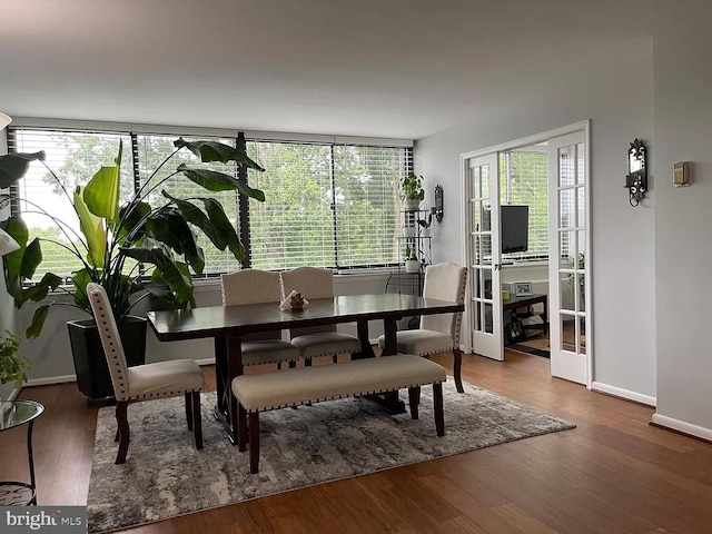 dining room with wood-type flooring and french doors