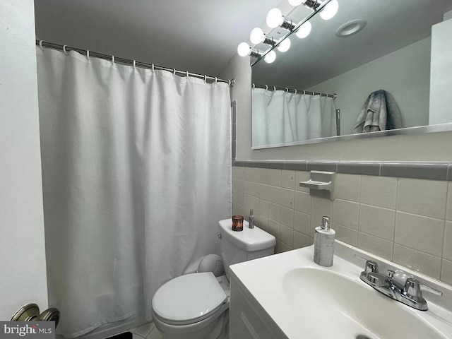 bathroom with a shower with shower curtain, vanity, toilet, and tile walls