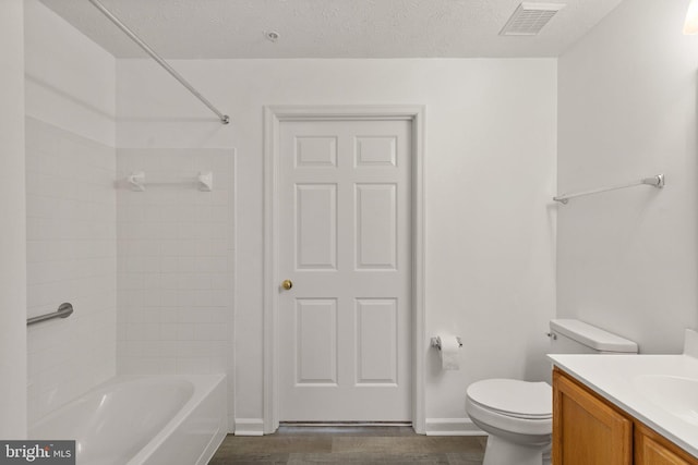 full bathroom with a textured ceiling, wood-type flooring, toilet, shower / bathtub combination, and vanity