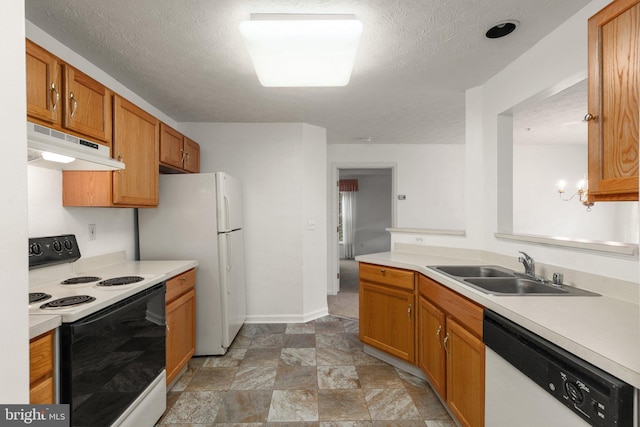 kitchen featuring sink, a textured ceiling, and white appliances