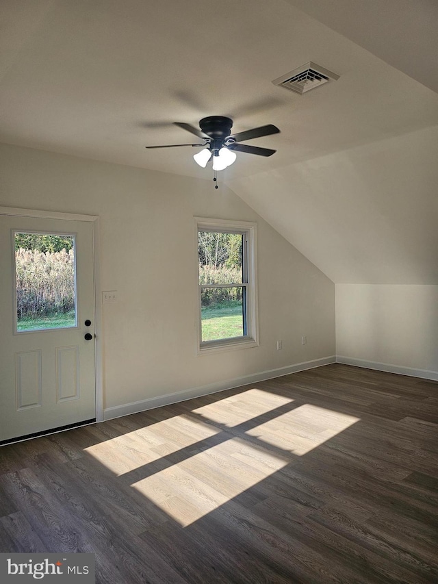 additional living space with dark hardwood / wood-style floors, ceiling fan, and vaulted ceiling