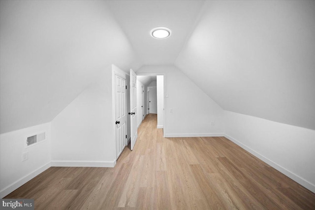 bonus room featuring light hardwood / wood-style floors and vaulted ceiling