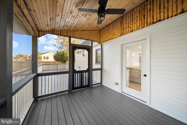 unfurnished sunroom with lofted ceiling, ceiling fan, and wooden ceiling