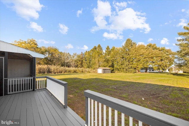 deck featuring a shed and a yard