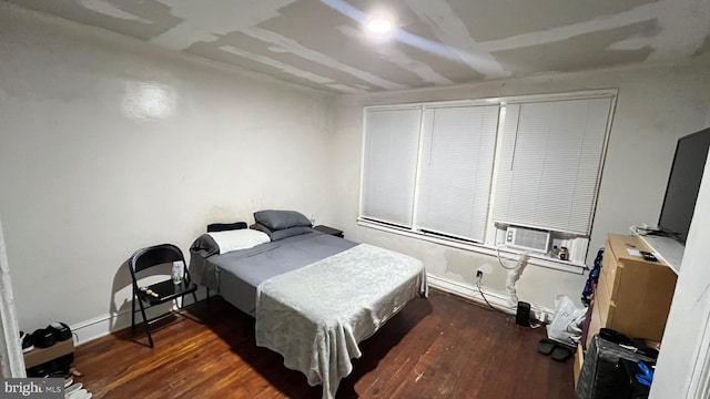 bedroom with dark wood-type flooring and cooling unit