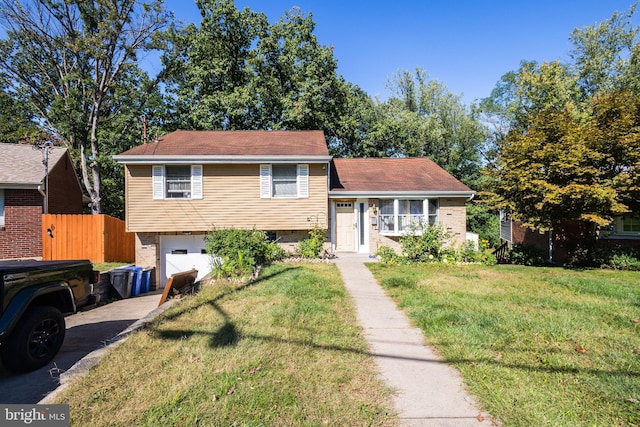 tri-level home with a front lawn and a garage