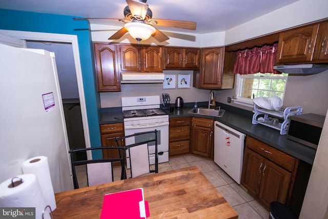 kitchen with white appliances, sink, light tile patterned floors, and ceiling fan