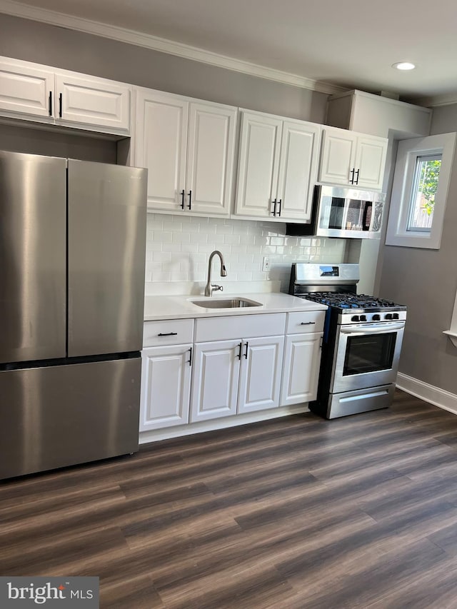 kitchen with sink, white cabinetry, stainless steel appliances, and dark hardwood / wood-style floors