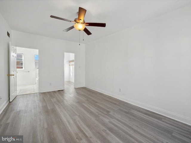 empty room featuring ceiling fan and hardwood / wood-style flooring