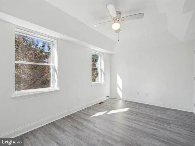 empty room featuring ceiling fan and dark hardwood / wood-style flooring