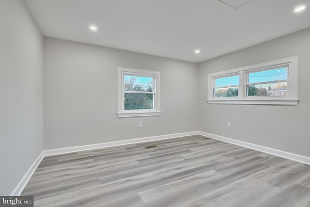 unfurnished room featuring light hardwood / wood-style flooring and a healthy amount of sunlight