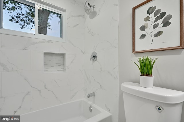 bathroom with toilet and tiled shower / bath combo