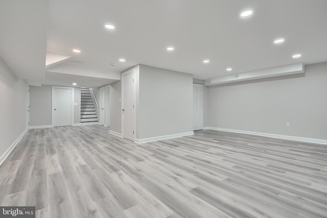 basement with light hardwood / wood-style floors