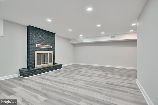 unfurnished living room with light hardwood / wood-style flooring and a fireplace