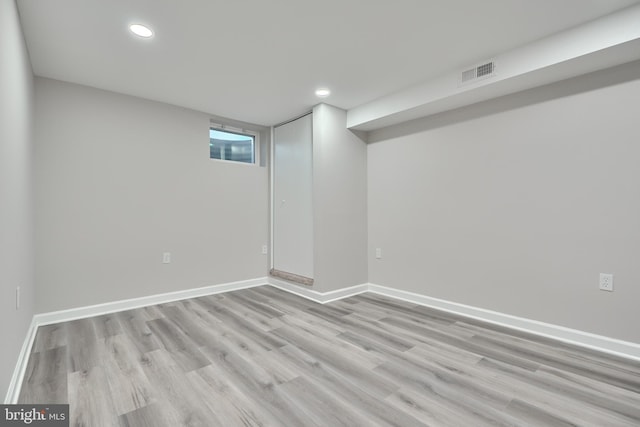 basement with light hardwood / wood-style flooring