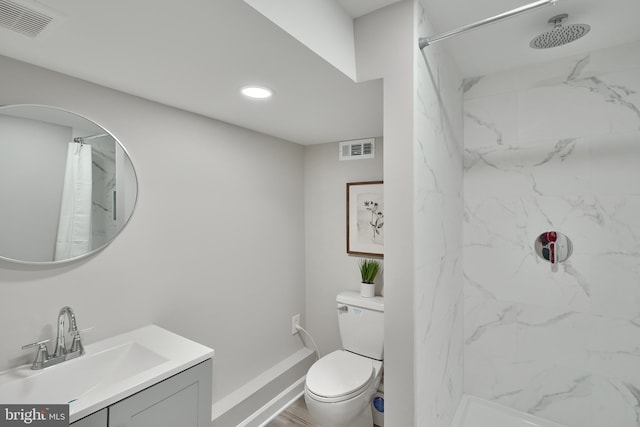 bathroom featuring toilet, curtained shower, and vanity