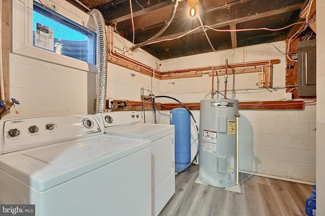 laundry area with independent washer and dryer, water heater, electric panel, and wood-type flooring