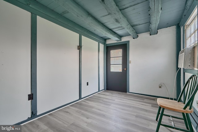 unfurnished sunroom featuring beam ceiling, wooden ceiling, and plenty of natural light