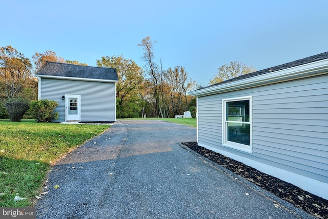 view of side of home featuring a lawn